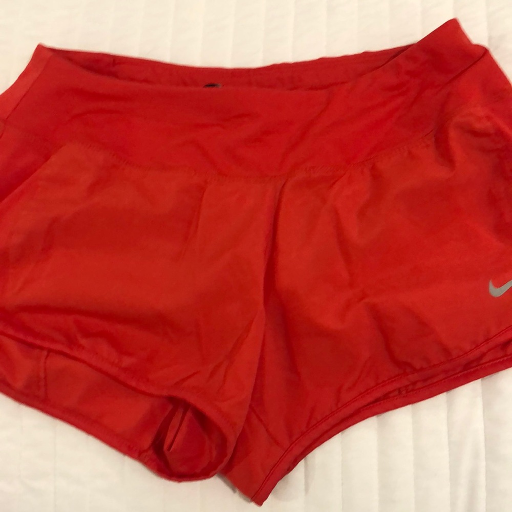 Dry fit Nike small reddish orange athletic shorts.